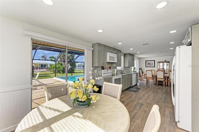 dining room with dark hardwood / wood-style flooring and sink