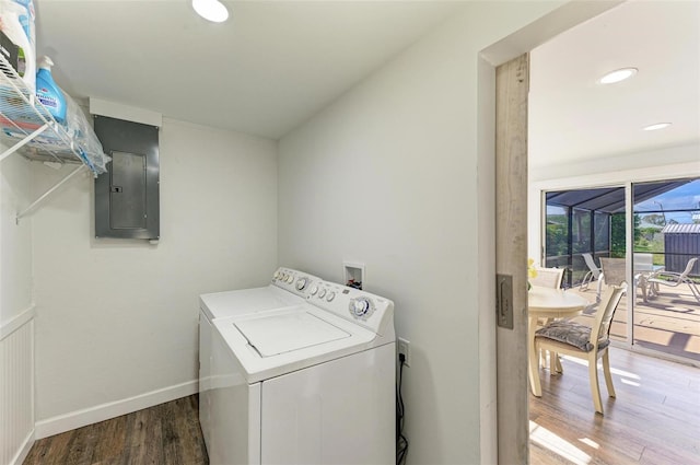 laundry area with washer and clothes dryer, dark wood-type flooring, and electric panel