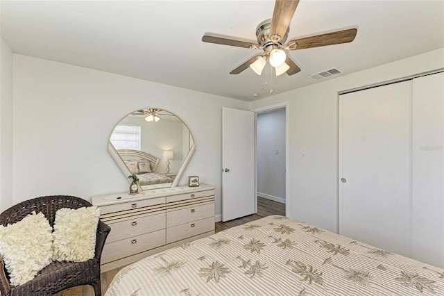 bedroom with ceiling fan, a closet, and hardwood / wood-style flooring