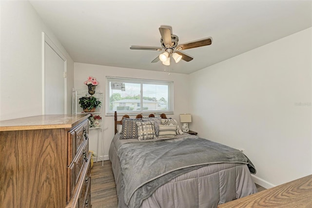 bedroom with ceiling fan and dark hardwood / wood-style flooring