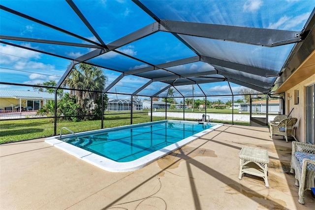 view of pool featuring a yard, a patio, and a lanai