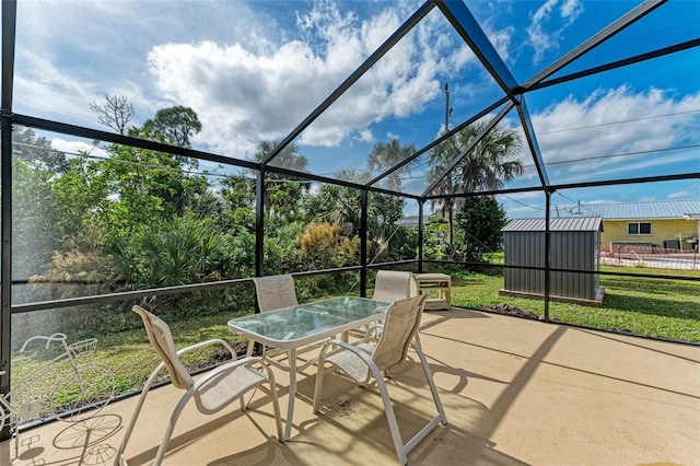 view of patio with a lanai and a shed