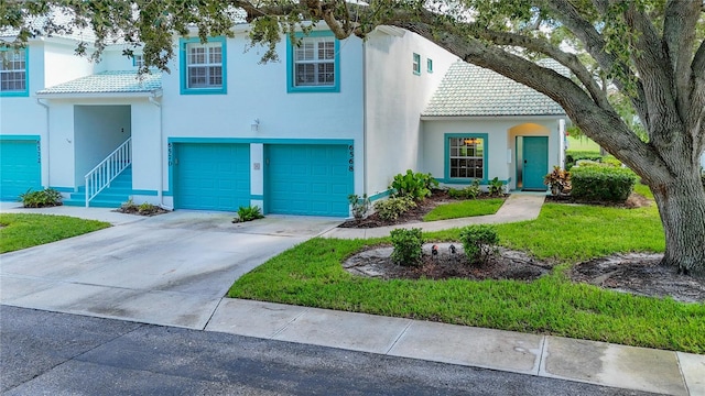 view of front of property featuring a garage and a front lawn