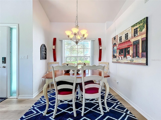 dining area featuring hardwood / wood-style flooring and a chandelier