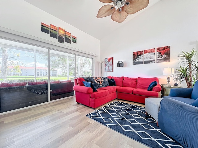 living room featuring high vaulted ceiling, hardwood / wood-style floors, and ceiling fan