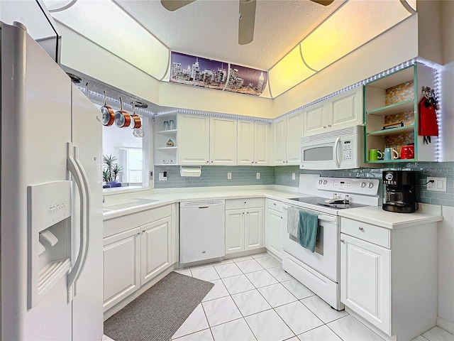 kitchen featuring white cabinetry, white appliances, decorative backsplash, and a textured ceiling