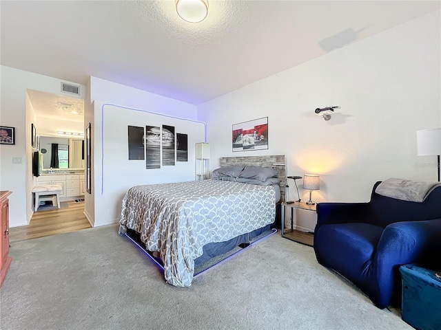 carpeted bedroom featuring ensuite bathroom