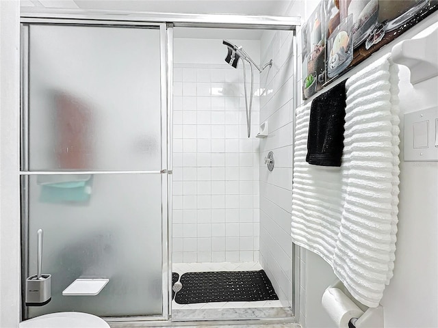 bathroom with walk in shower and toilet