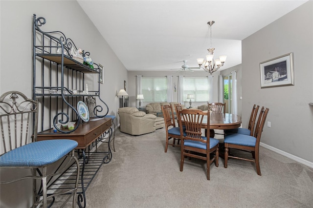 dining room with light carpet, lofted ceiling, and ceiling fan with notable chandelier