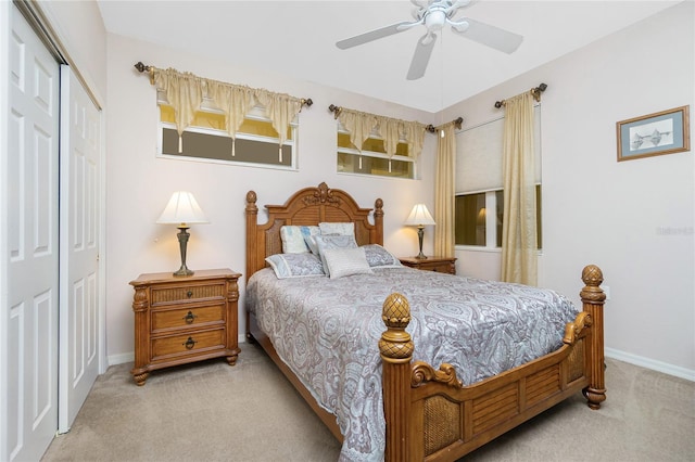 carpeted bedroom with ceiling fan and a closet