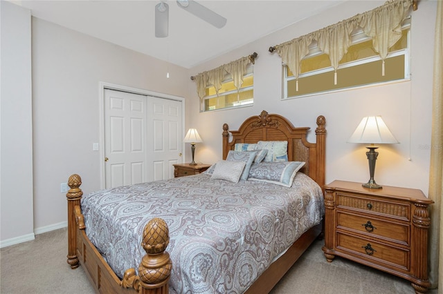 bedroom with a closet, ceiling fan, and light colored carpet