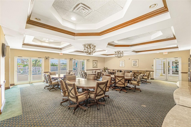 carpeted dining room featuring a tray ceiling, crown molding, and french doors