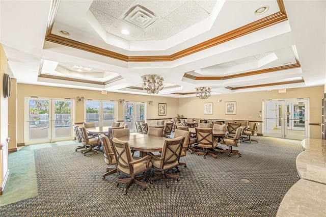 carpeted dining room featuring visible vents, a raised ceiling, crown molding, and french doors