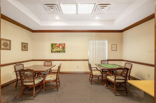 carpeted dining space featuring crown molding, a paneled ceiling, and a tray ceiling