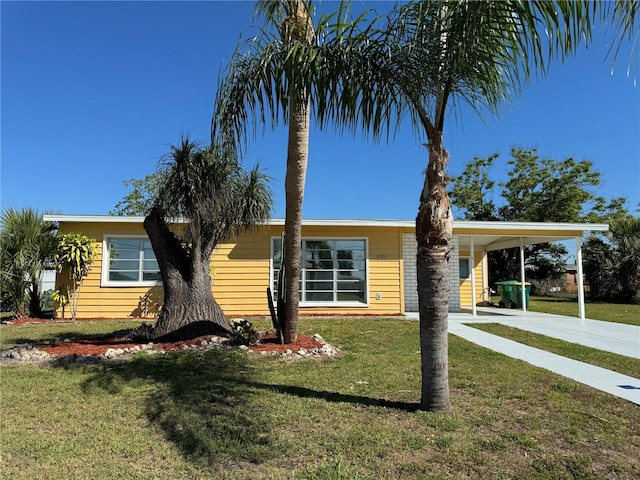 ranch-style home with a carport and a front lawn