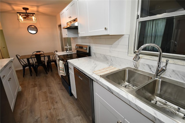 kitchen with tasteful backsplash, dark wood-type flooring, stainless steel appliances, sink, and white cabinets