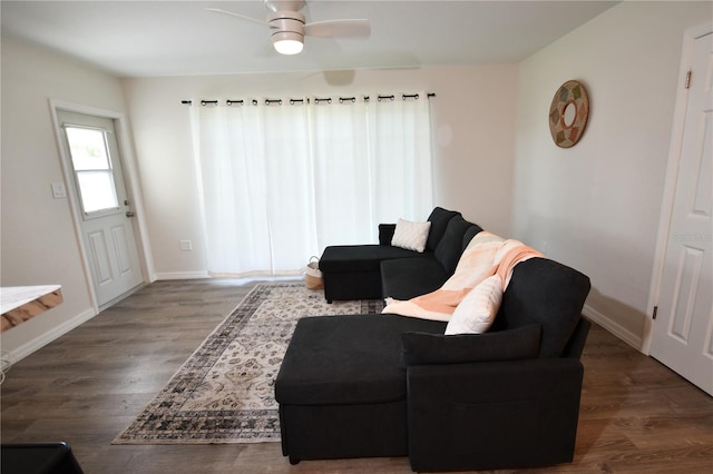 living room with ceiling fan and dark hardwood / wood-style floors