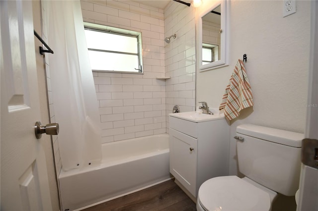 full bathroom featuring plenty of natural light, toilet, vanity, and wood-type flooring