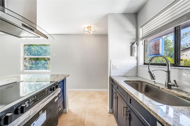 1001 W Marion Ave Unit 14, Punta Gorda, FL 33950 - kitchen with exhaust hood, light stone countertops, light tile patterned flooring, a sink, and stainless steel electric range
