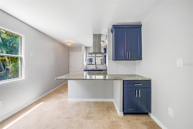 1001 W Marion Ave Unit 14, Punta Gorda, FL 33950 - kitchen featuring island range hood, light stone countertops, blue cabinetry, and decorative backsplash