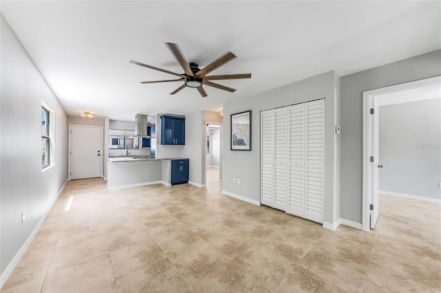 1001 W Marion Ave Unit 14, Punta Gorda, FL 33950 - unfurnished living room with baseboards, a ceiling fan, and light tile patterned flooring