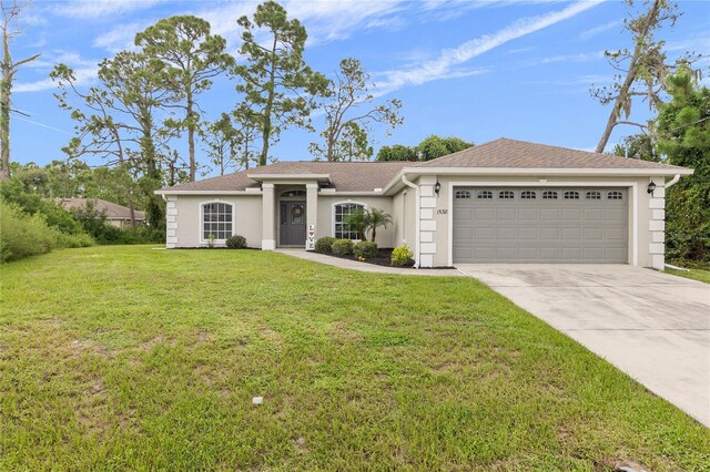 ranch-style home featuring a garage and a front yard