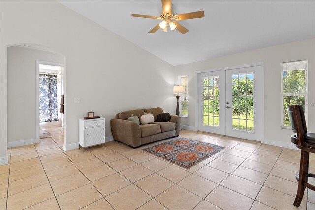 living room with french doors, vaulted ceiling, ceiling fan, and light tile patterned flooring