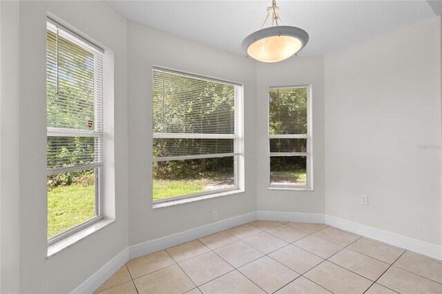 spare room featuring light tile patterned flooring