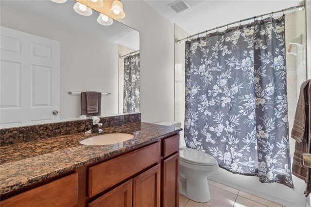 full bathroom with tile patterned floors, toilet, shower / bath combo with shower curtain, and vanity