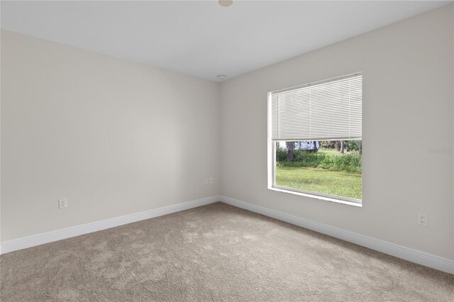 empty room featuring light colored carpet