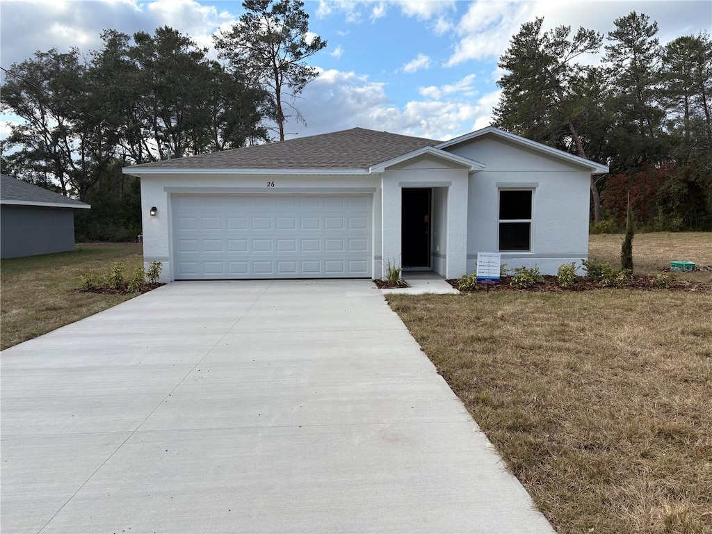 view of front of house featuring a front yard and a garage