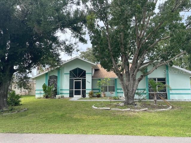 269 Rosemary St, Port Charlotte, FL 33954 - view of front of property with a front yard and stucco siding