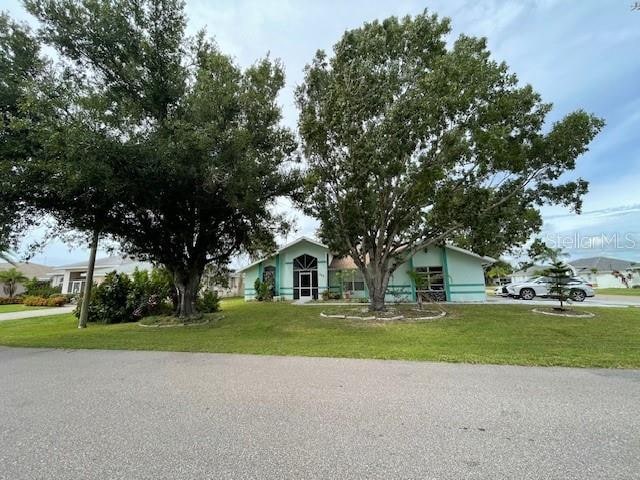 ranch-style house with a front lawn