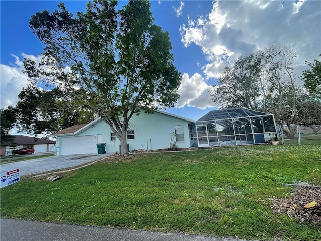 view of front of property featuring glass enclosure, a front lawn, and a garage