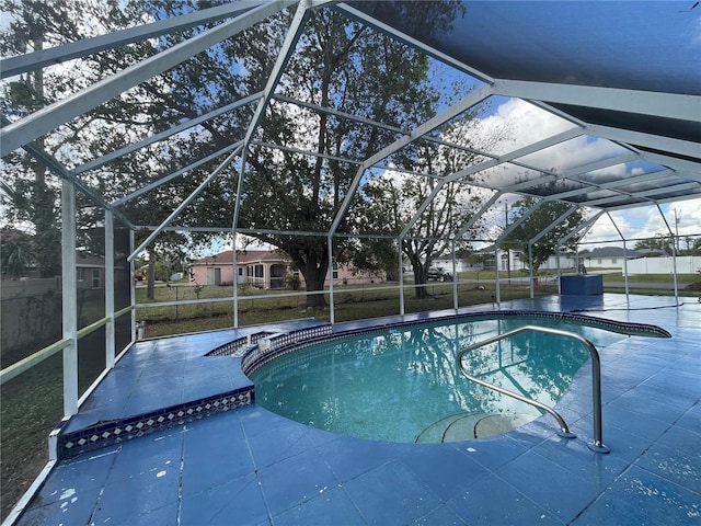 view of pool with a patio and glass enclosure