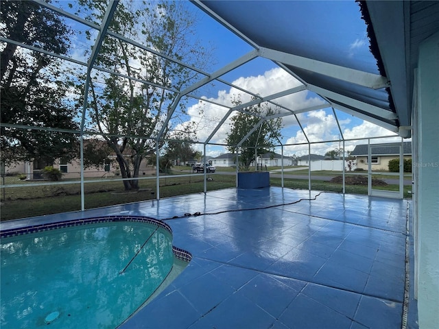 view of swimming pool featuring a lanai and a yard