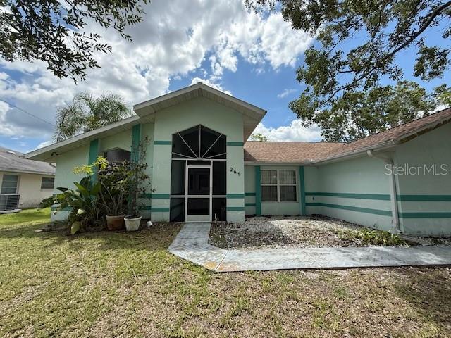 269 Rosemary St, Port Charlotte, FL 33954 - view of front of property featuring a front yard