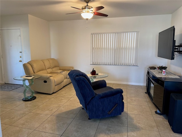 living room featuring light tile patterned flooring and ceiling fan