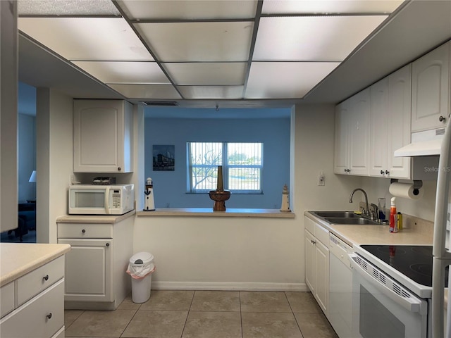 kitchen featuring white cabinetry, sink, and white appliances