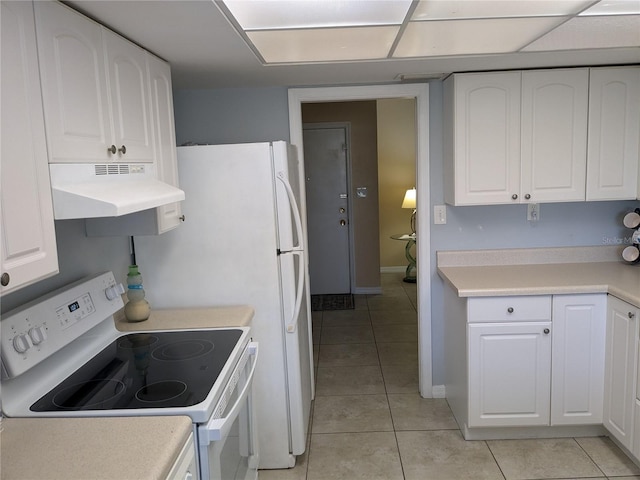 kitchen featuring light tile patterned flooring, white electric stove, and white cabinets