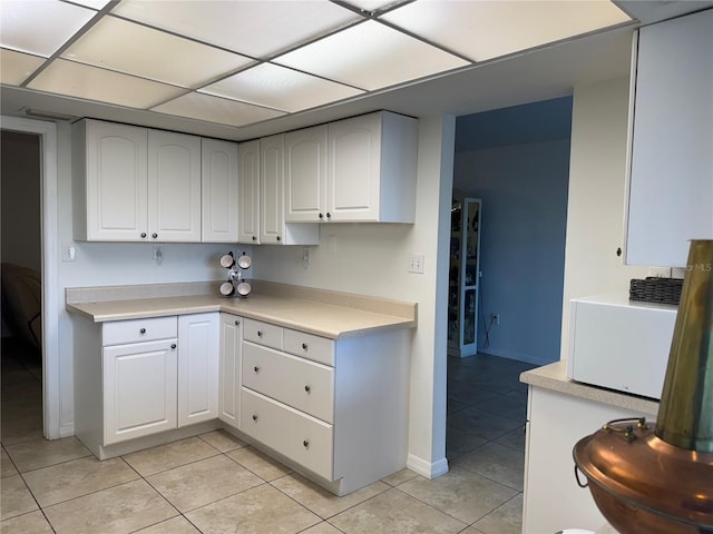 kitchen featuring white cabinetry and light tile patterned floors