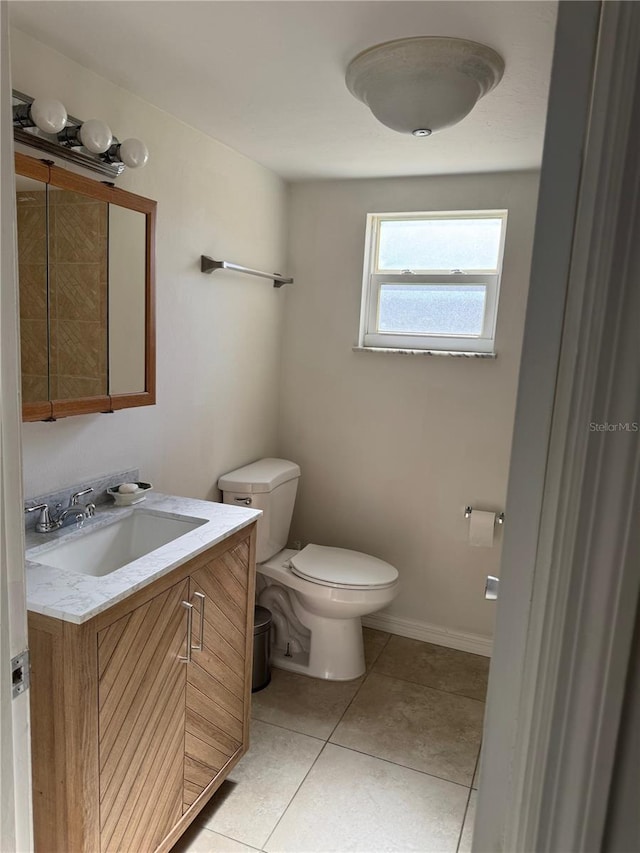 bathroom with vanity, tile patterned floors, and toilet