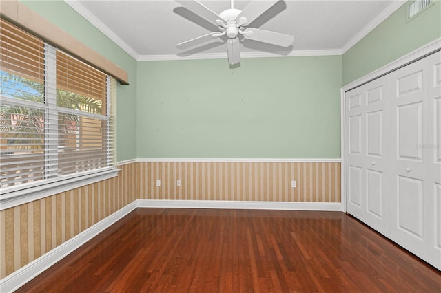 interior space featuring crown molding, ceiling fan, a closet, and dark hardwood / wood-style flooring