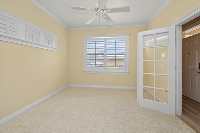 empty room featuring crown molding, hardwood / wood-style flooring, and ceiling fan