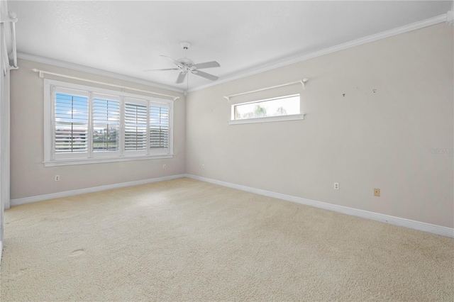 empty room featuring crown molding, ceiling fan, and light colored carpet