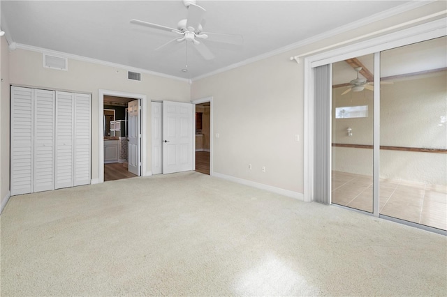 unfurnished bedroom with crown molding, ceiling fan, and carpet floors