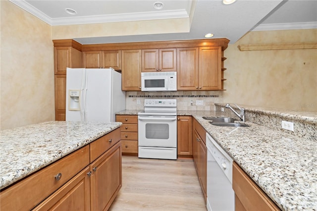 kitchen featuring backsplash, white appliances, light stone counters, light hardwood / wood-style floors, and sink