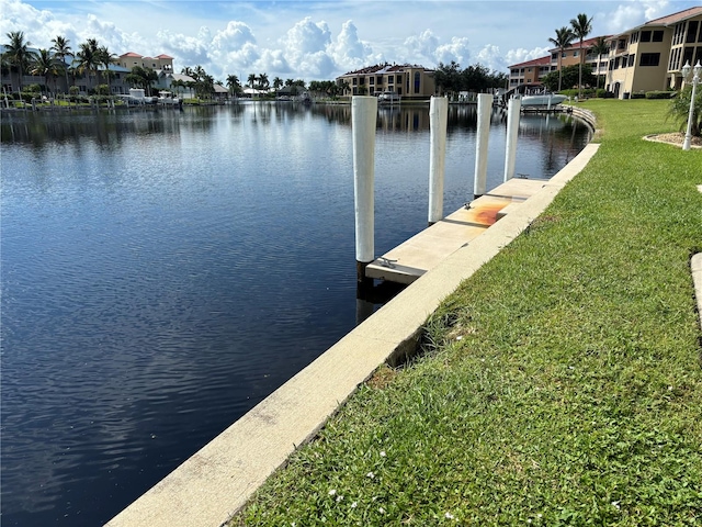 view of dock featuring a water view and a lawn