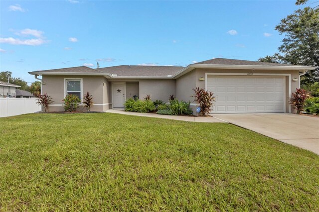 single story home with a front yard and a garage