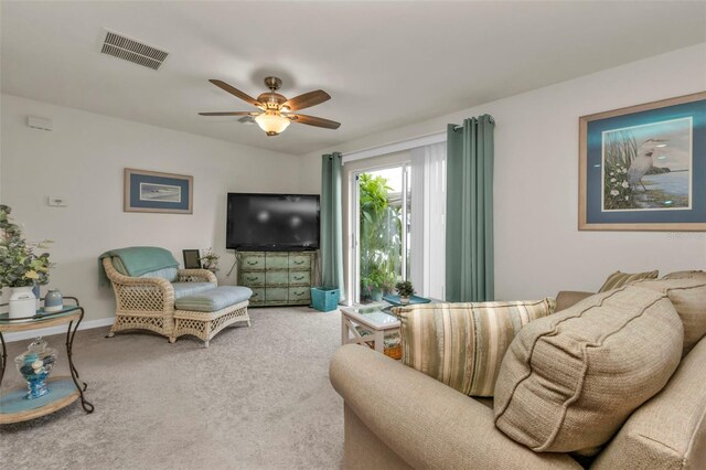 carpeted living room featuring ceiling fan